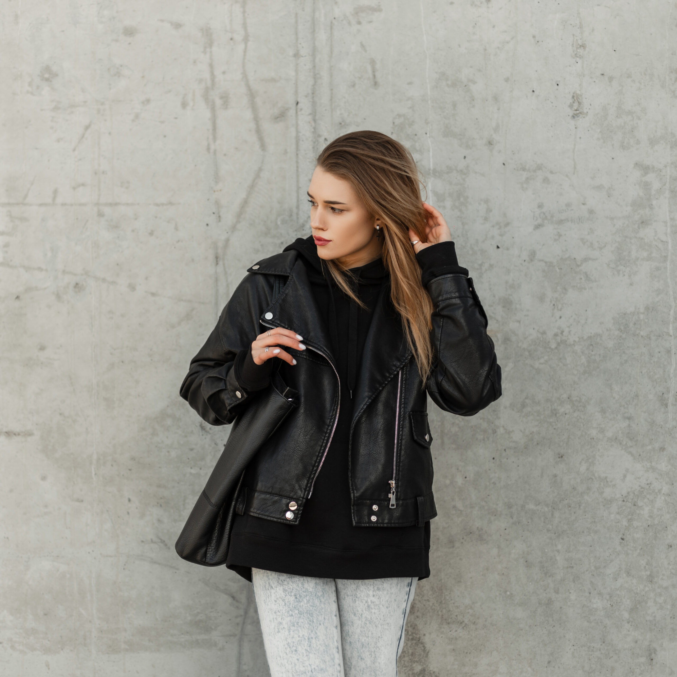 beautiful girl in fashionable clothes with a leather jacket and